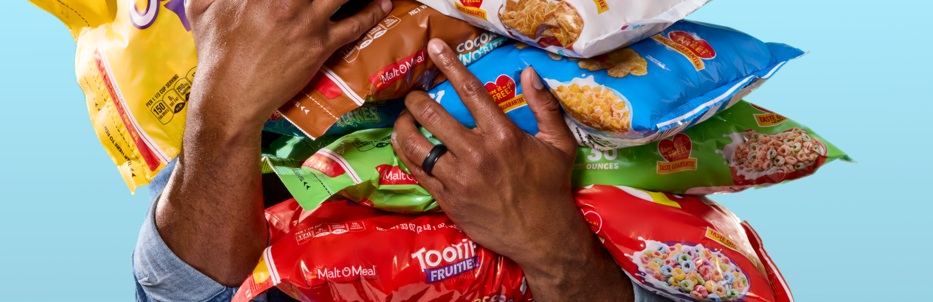 Holding a lot of bags of Malt-O-Meal cereal