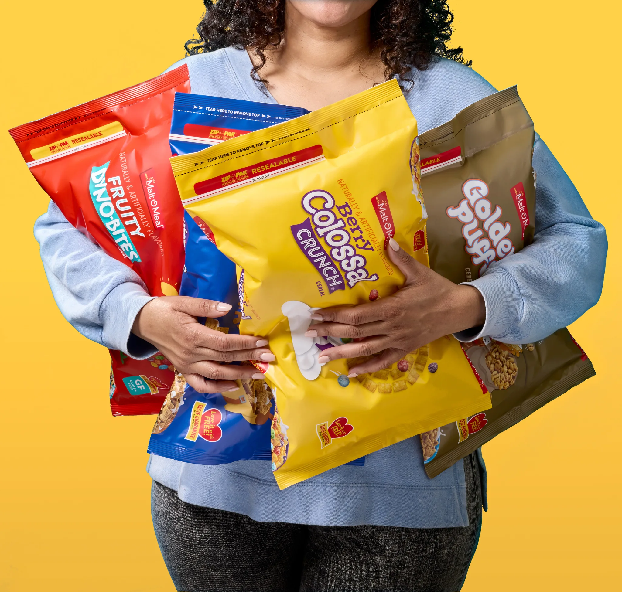 Woman holding bags of Malt-O-Meal cereal